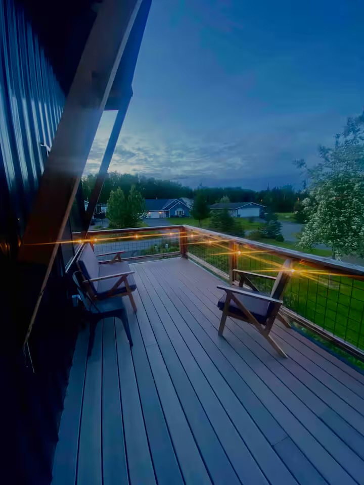 Private rooftop deck at Knoll House at dusk with string lights